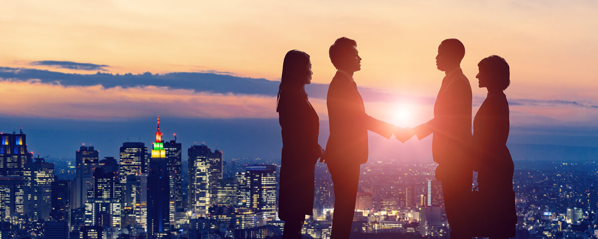 Japanese and international businesspeople meeting each other with the city in the background